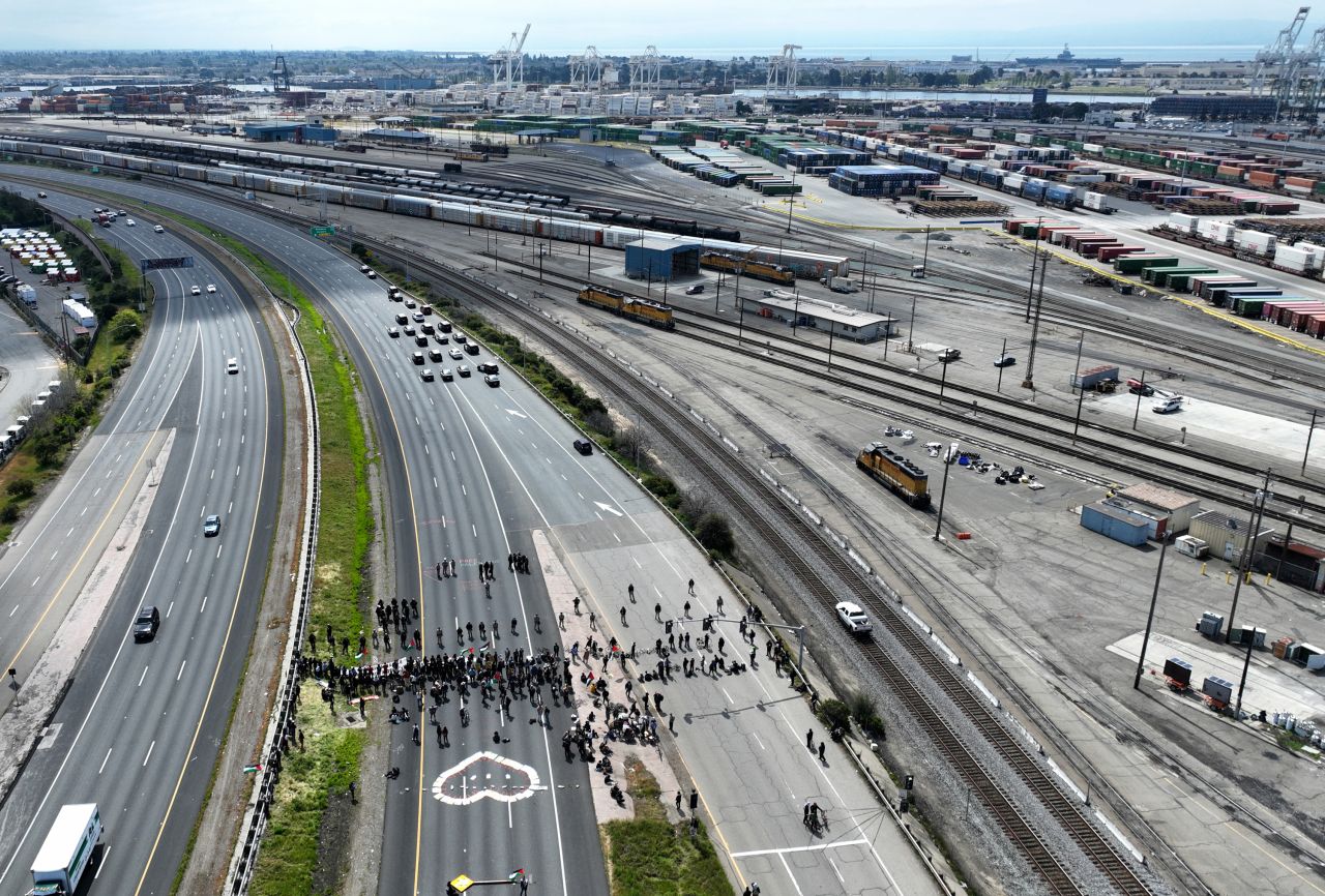 Protesters are monitored by California Highway Patrol officers on Interstate 880 southbound near the 7th Avenue on ramp in West Oakland, California, on April 15.