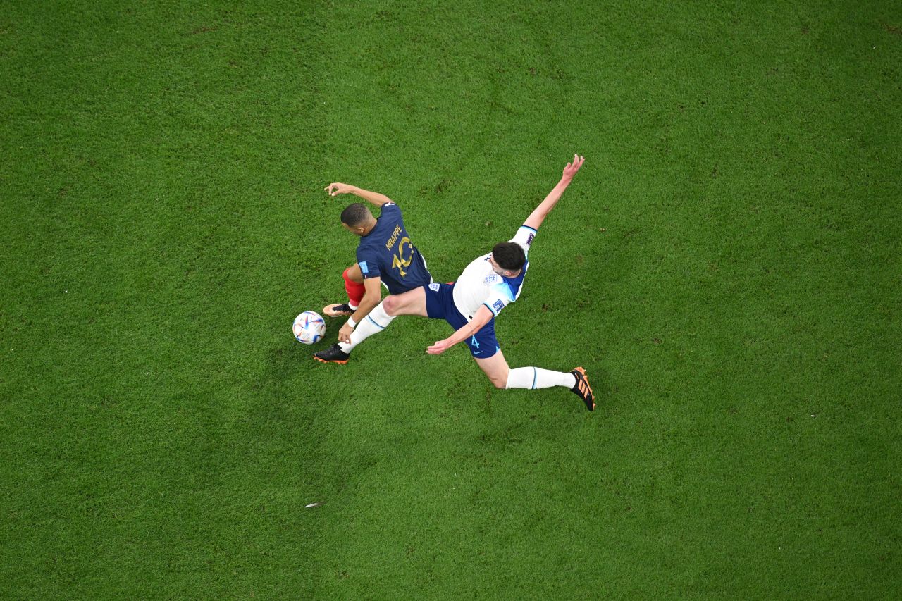 Kylian Mbappé is tackled by Declan Rice of England during a tense match-up between the two rivals.