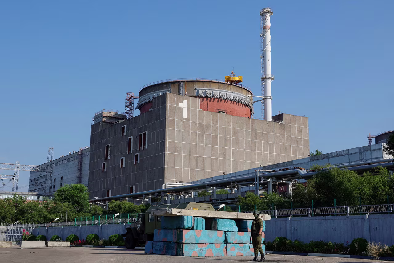 A Russian service member stands guard at a checkpoint near the Zaporizhzhia Nuclear Power Plant on June 15.