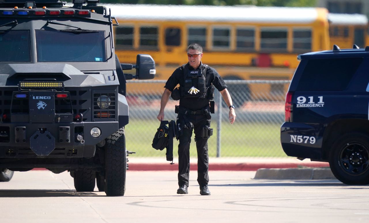 A law enforcement officer walks in the parking lot of Timberview High School after a shooting inside the school in south Arlington, Texas on October 6.