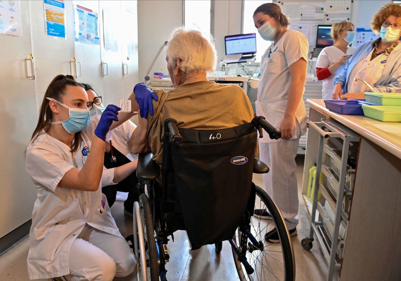 A nurse administers a dose of the Pfizer-BioNtech Covid-19 vaccine to an elderly person in the Bellevue gerontology center in Montpellier, France on January 4