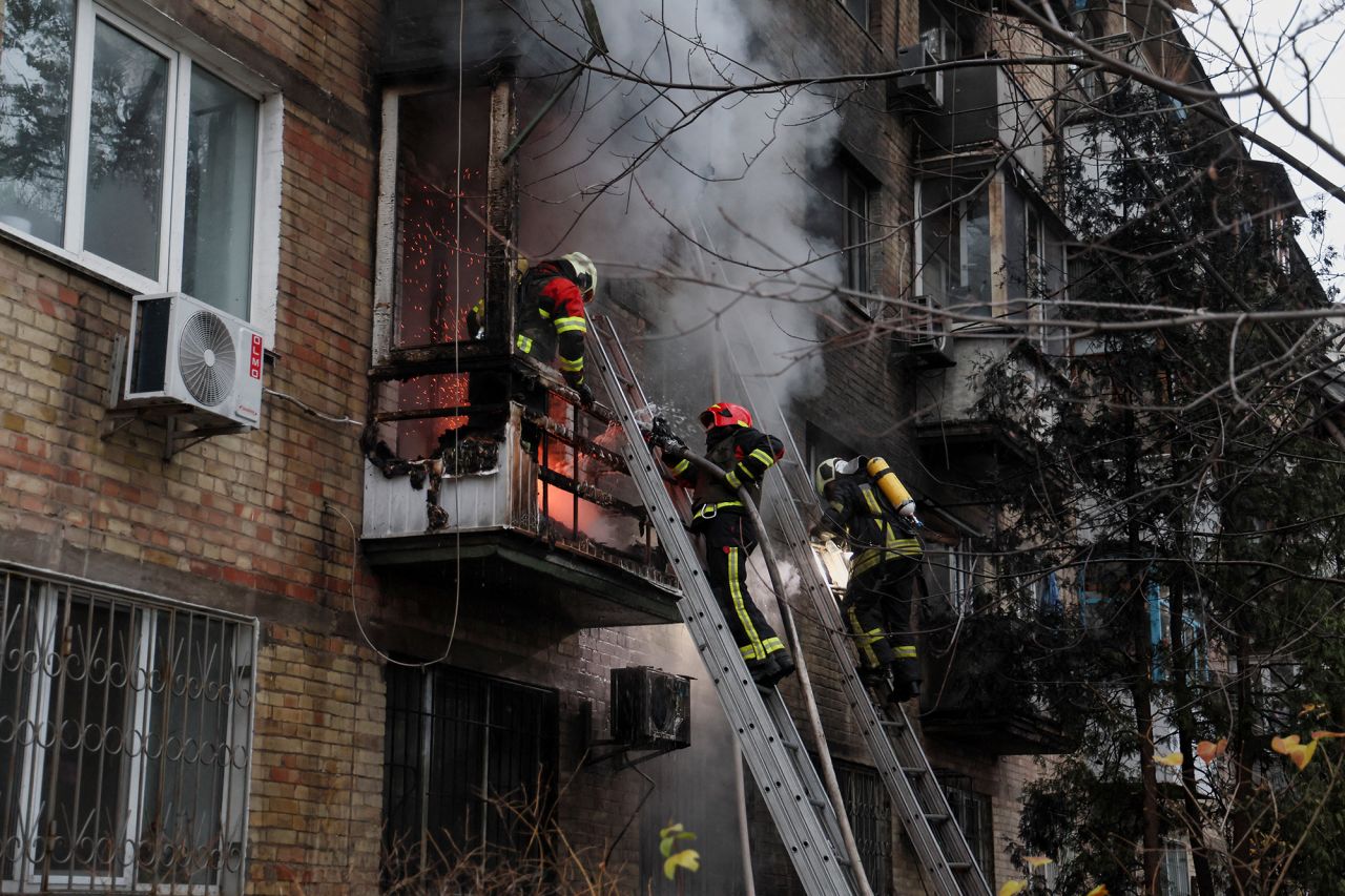 Firefighters work to put out a fire in a residential building hit by a Russian missile strike in Kyiv, Ukraine, on November 15.