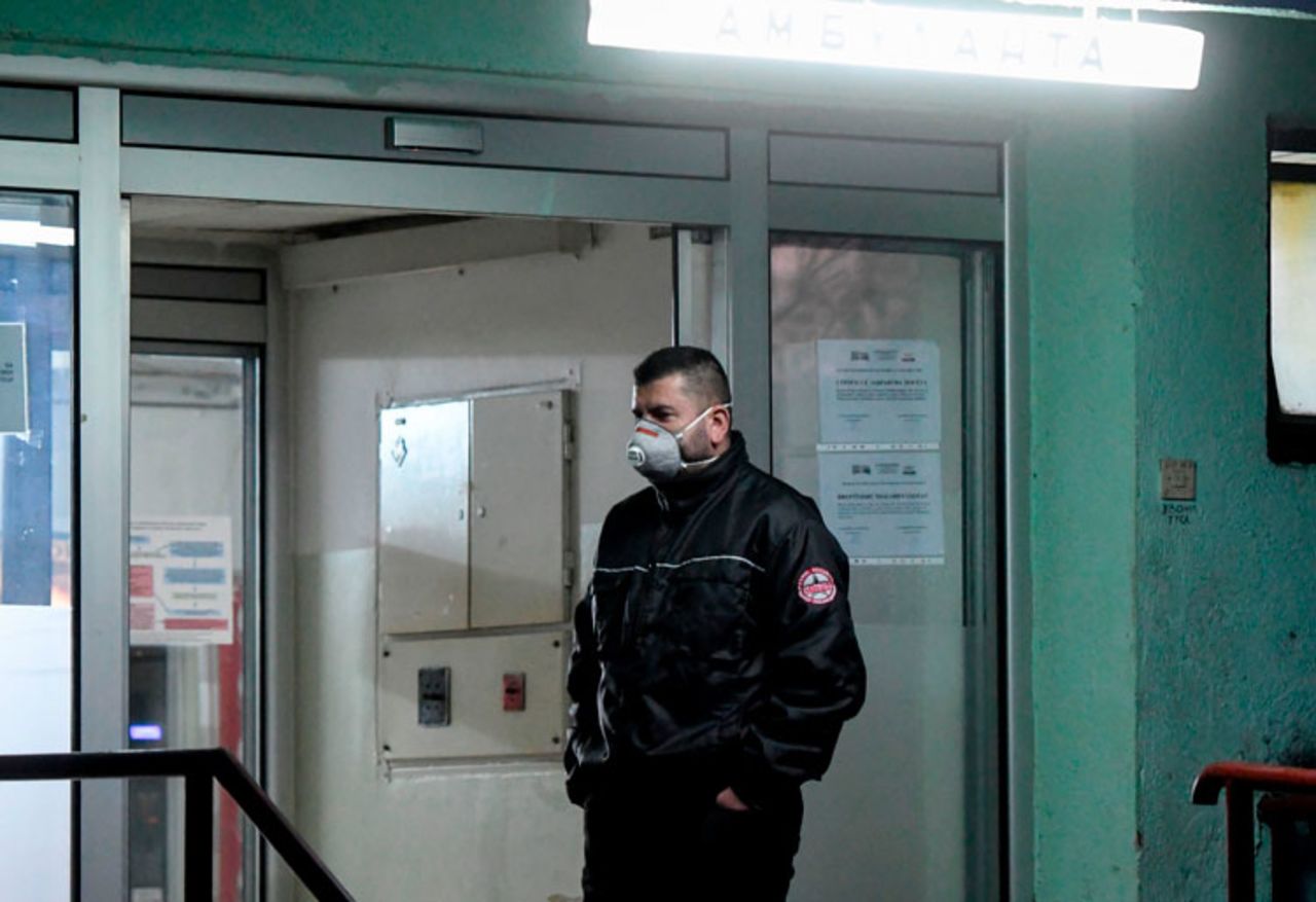 A security guard wearing protective face masks stands guard in front of the University Clinic for Infectious Diseases in Skopje on February 26.