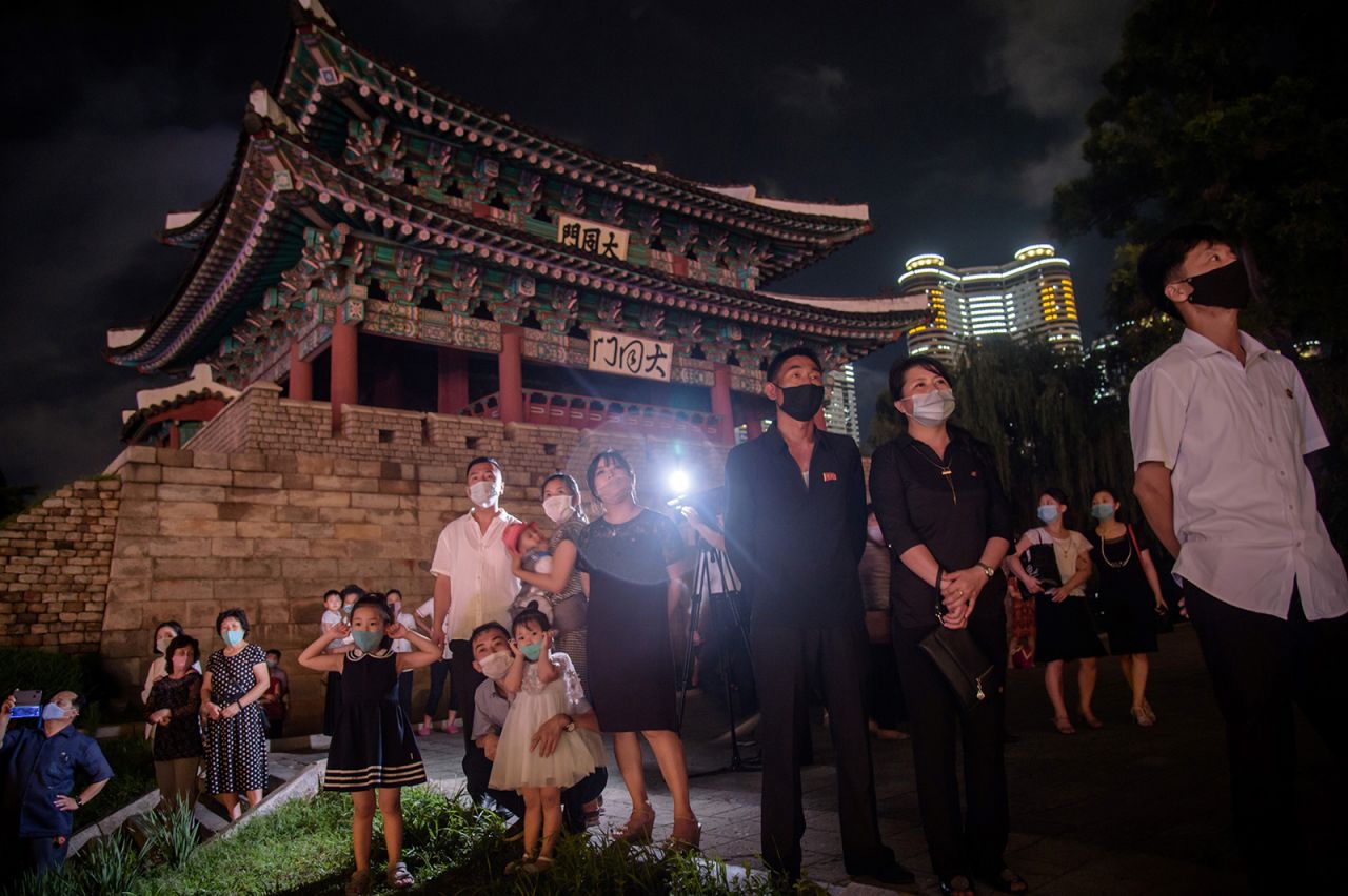 People stand at Taedongmun gate in Pyongyang to watch a firework display on July 27 to mark the 67th anniversary of the signing of the Korean War armistice agreement.