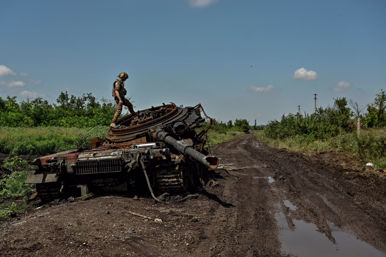 A Ukrainian serviceman inspects a destroyed Russian tank in the recently liberated village of Novodarivka in Zaporizhzhia region, Ukraine, on July 21, 2023.