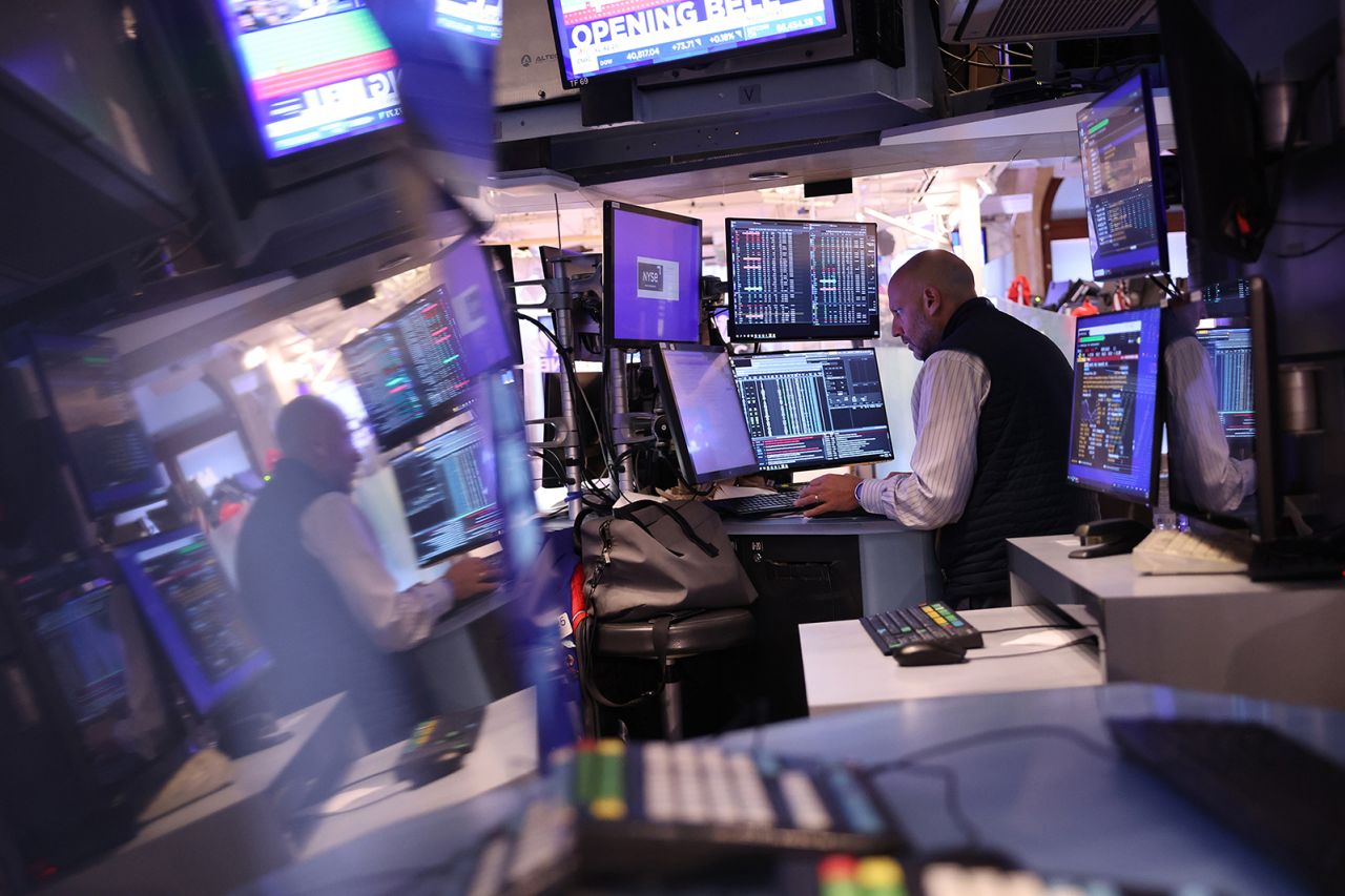 Traders work on the floor of the New York Stock Exchange during morning trading on July 31.