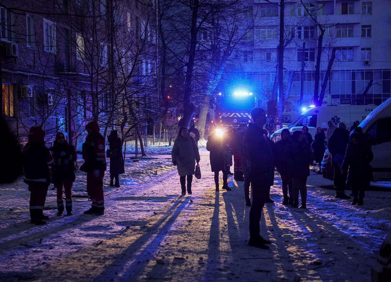 Local residents gather near a building destroyed by a Russian drone attack in Kyiv on December 14. 