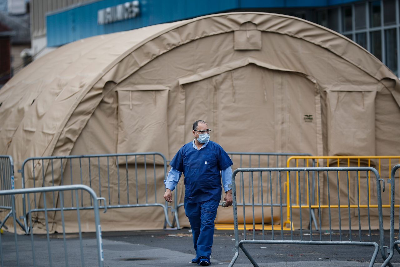 A medical worker walks past a testing tent outside SUNY Downstate Medical Center on March 27.