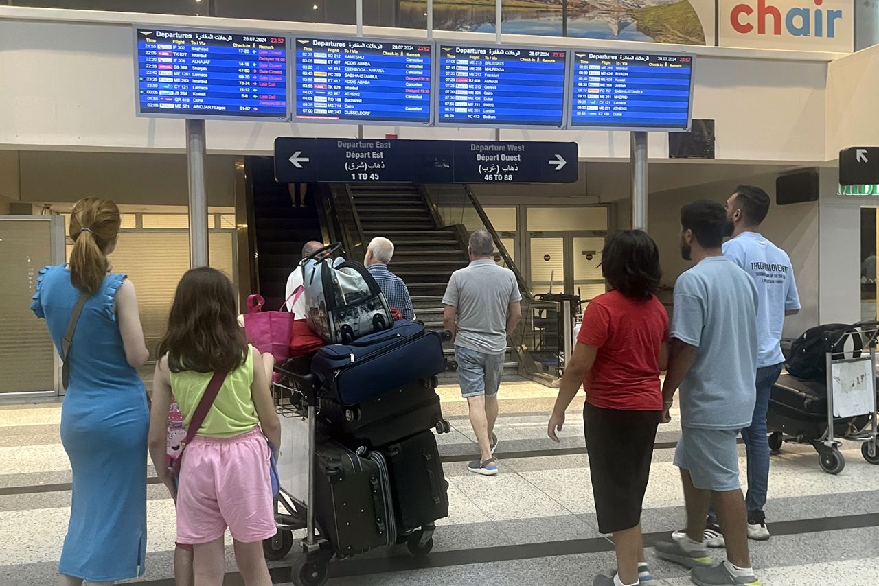 People wait to get updated information after some flights are delayed at Beirut Rafic Hariri International Airport on July 28.