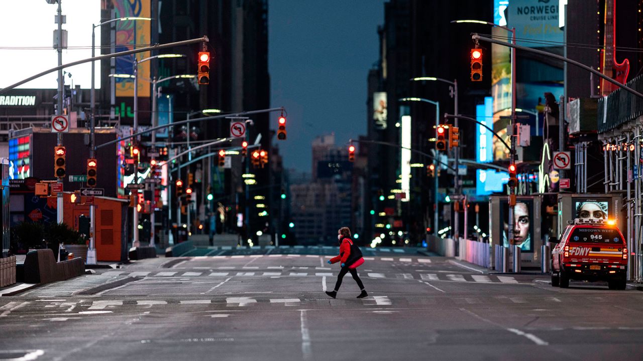 A woman walks through an almost-deserted Times Square in the early morning hours on April 23 in New York City. 