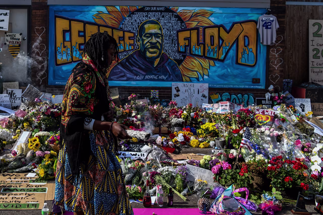 A woman burns sage and offers prayers as she pays her respects at a makeshift memorial in honor of George Floyd, on June 3, in Minneapolis, Minnesota.