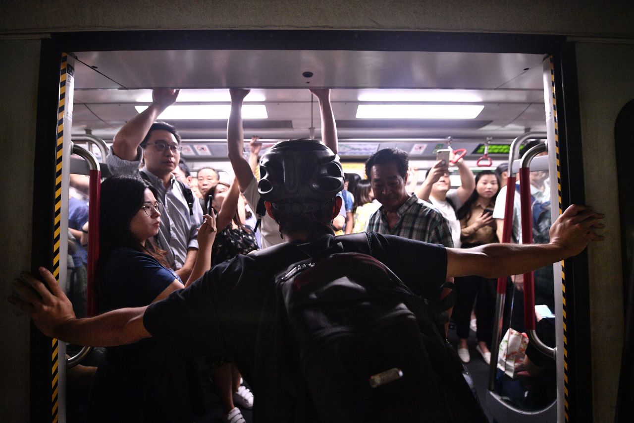 A protester blocks a subway train at Fortress Hill station on August 5.