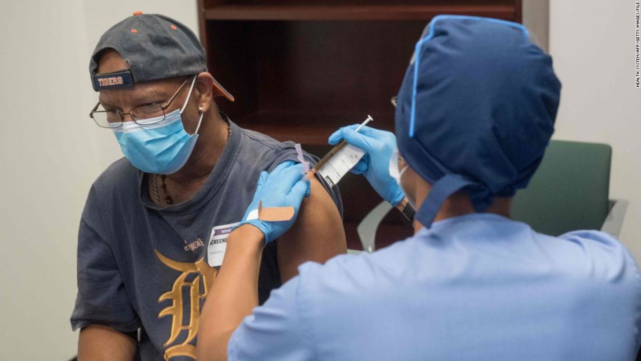 In this August 5, 2020 photo, a volunteer is given a Moderna mRNA-1273 Coronavirus Efficacy (COVE) shot during the first COVID-19 vaccine trial in Detroit, Michigan.