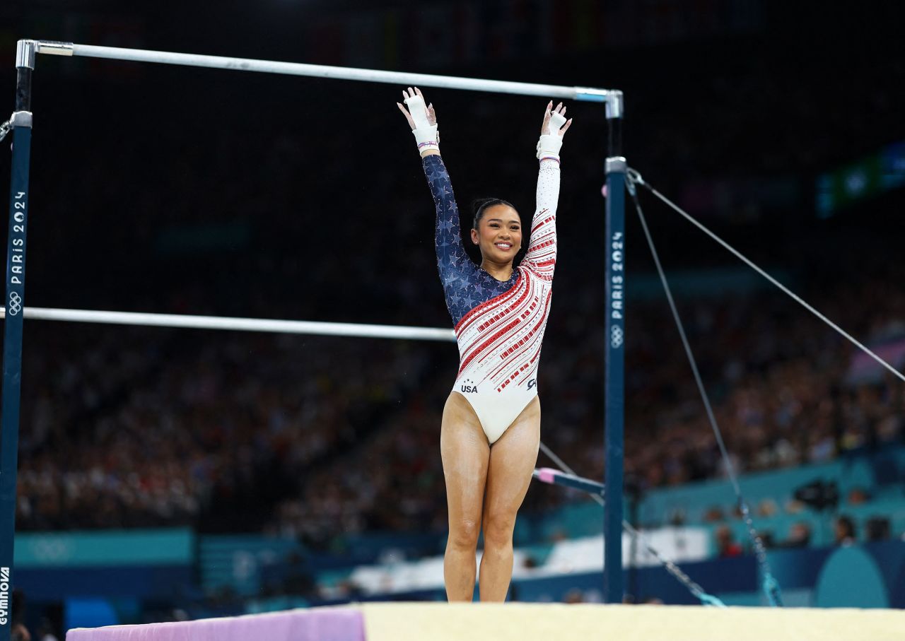 Suni Lee lands after her performance on the uneven bars on Tuesday.