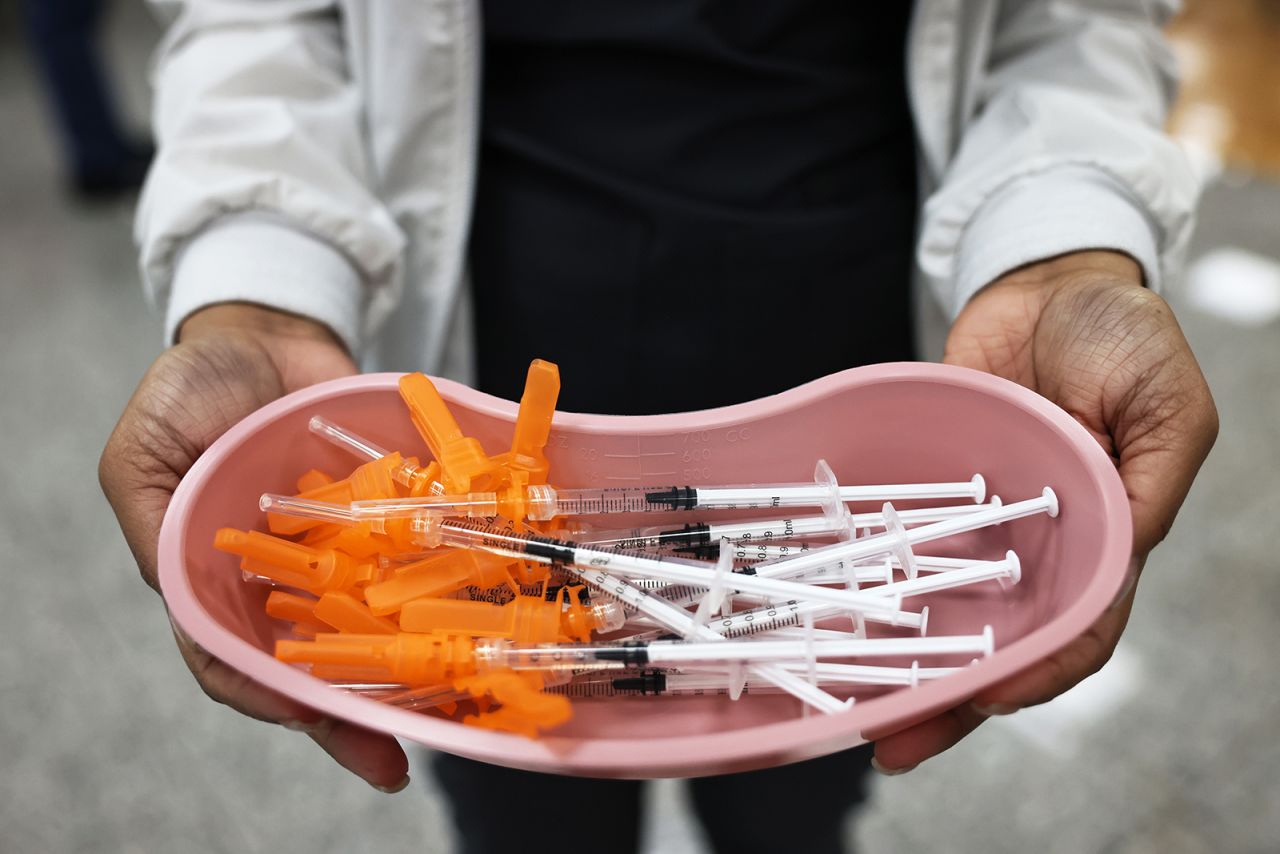 A medical worker with Northwell Health holds up doses of the Johnson & Johnson Covid-19 vaccine at a pop-up vaccination site at the Albanian Islamic Cultural Center in Staten Island on April 8 in New York.