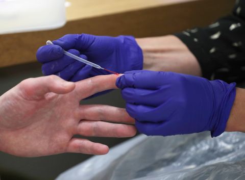 An antibody fingertip test for the detection of COVID-19 is conducted on a patient in London on May, 21.