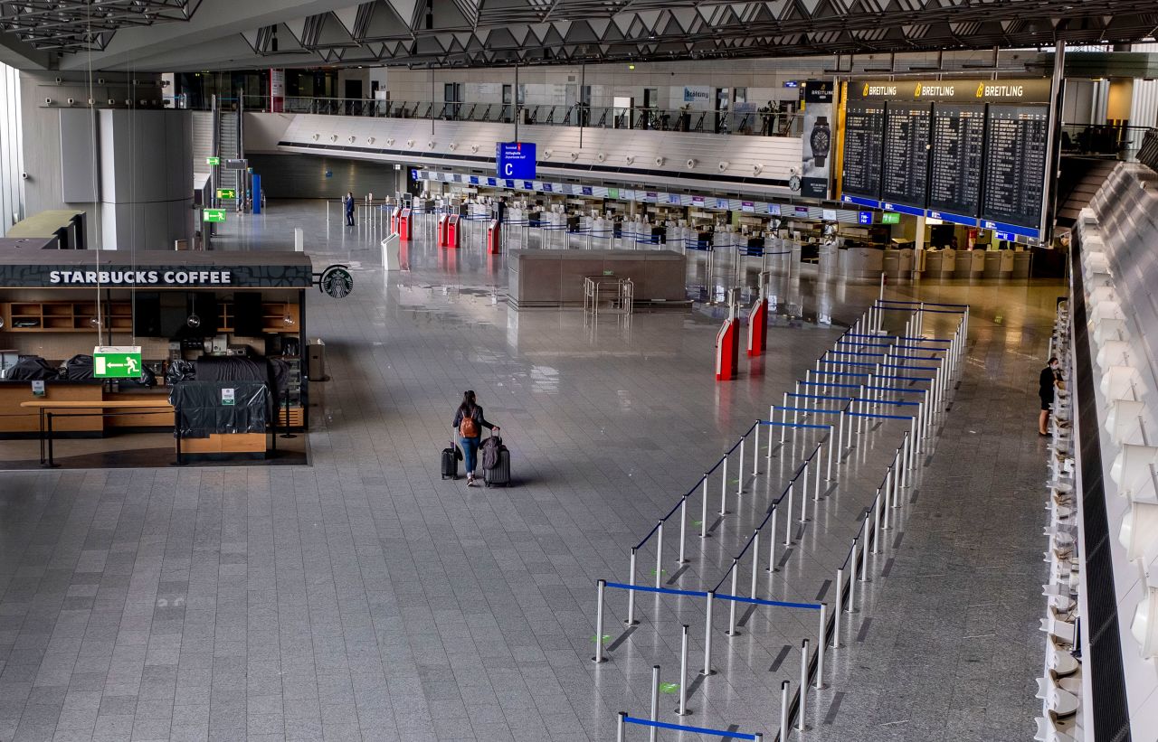 A passenger walks through a nearly empty airport in Frankfurt, Germany, on April 9.