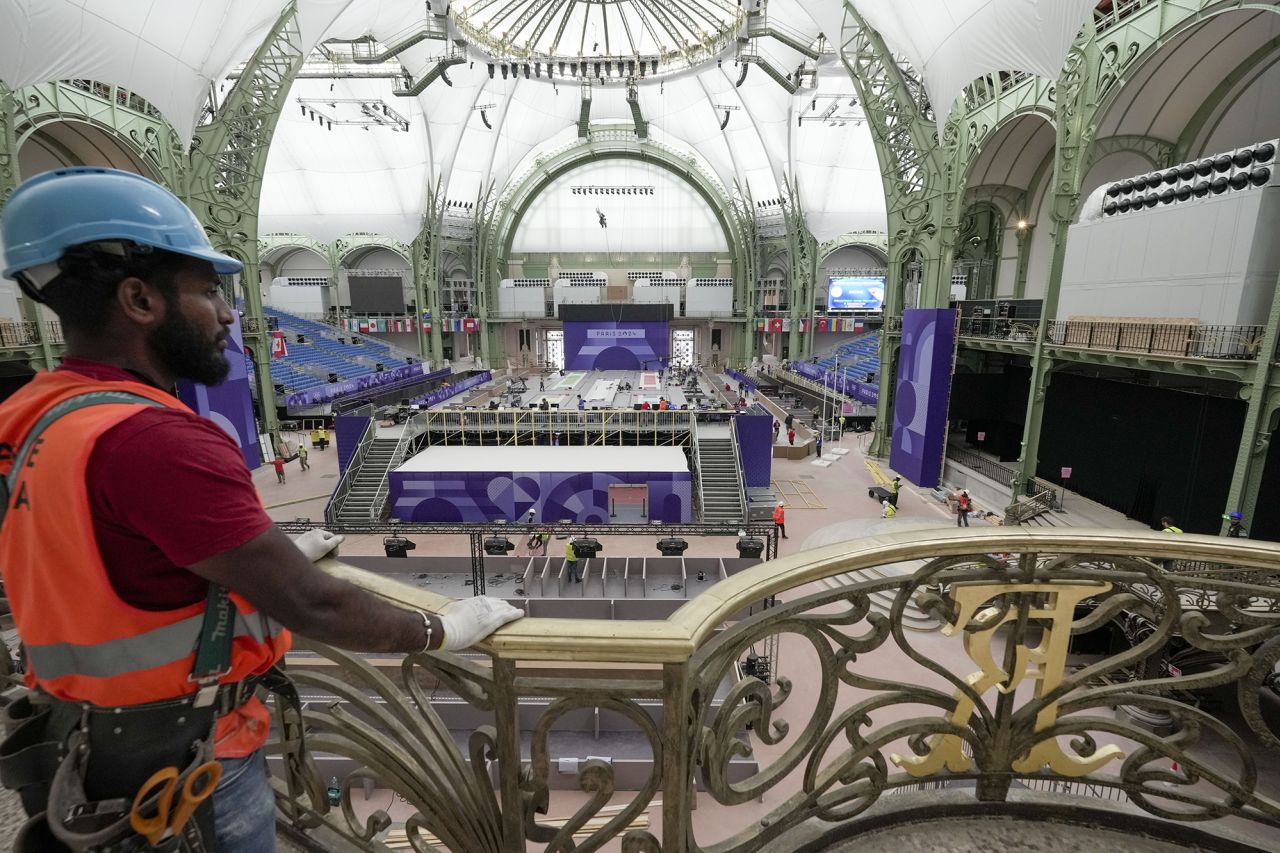 Workers apply the final touches on July 23 in Paris at the Grand Palais, the venue that will host fencing and Taekwondo at the 2024 Summer Olympics.