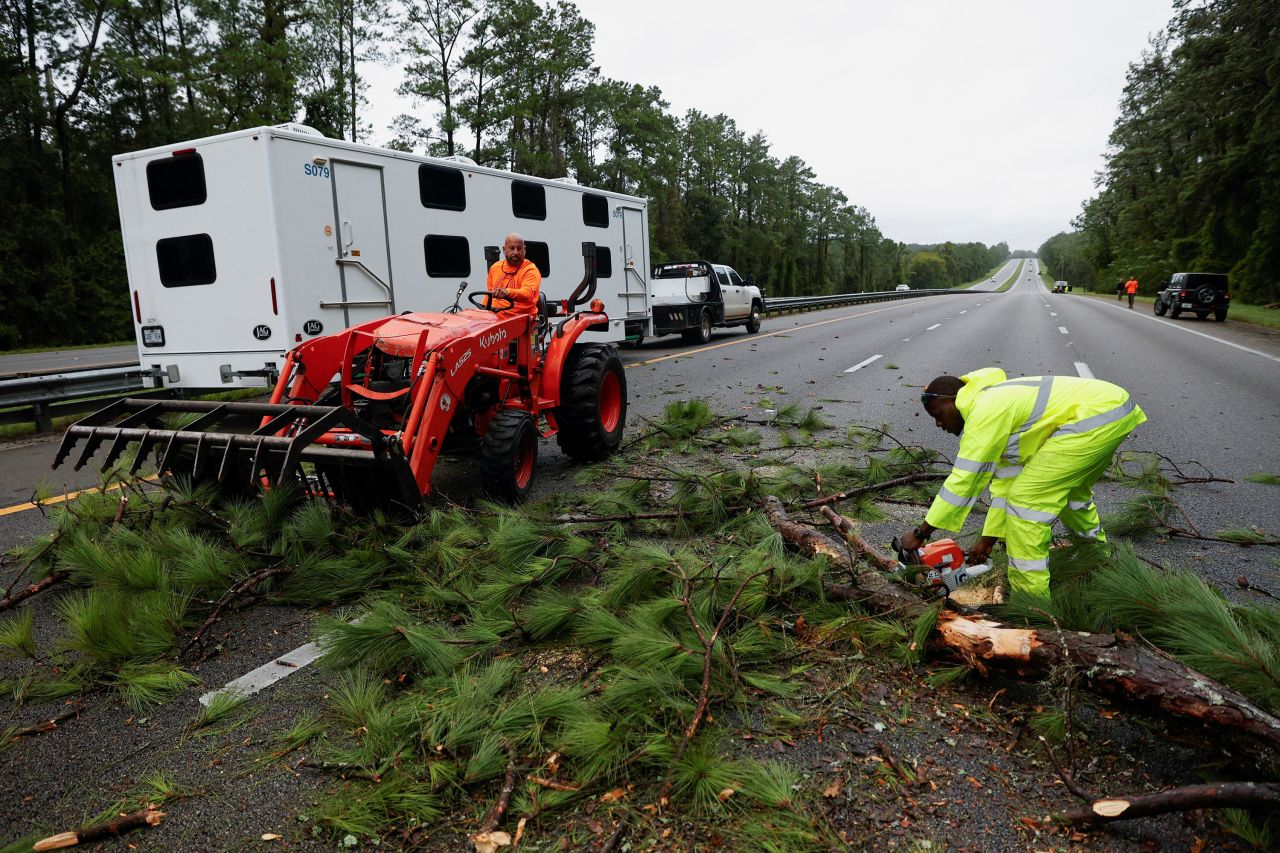 Workers clear tree branches from Interstate 75 near Gainesville, Florida, on Wednesday.