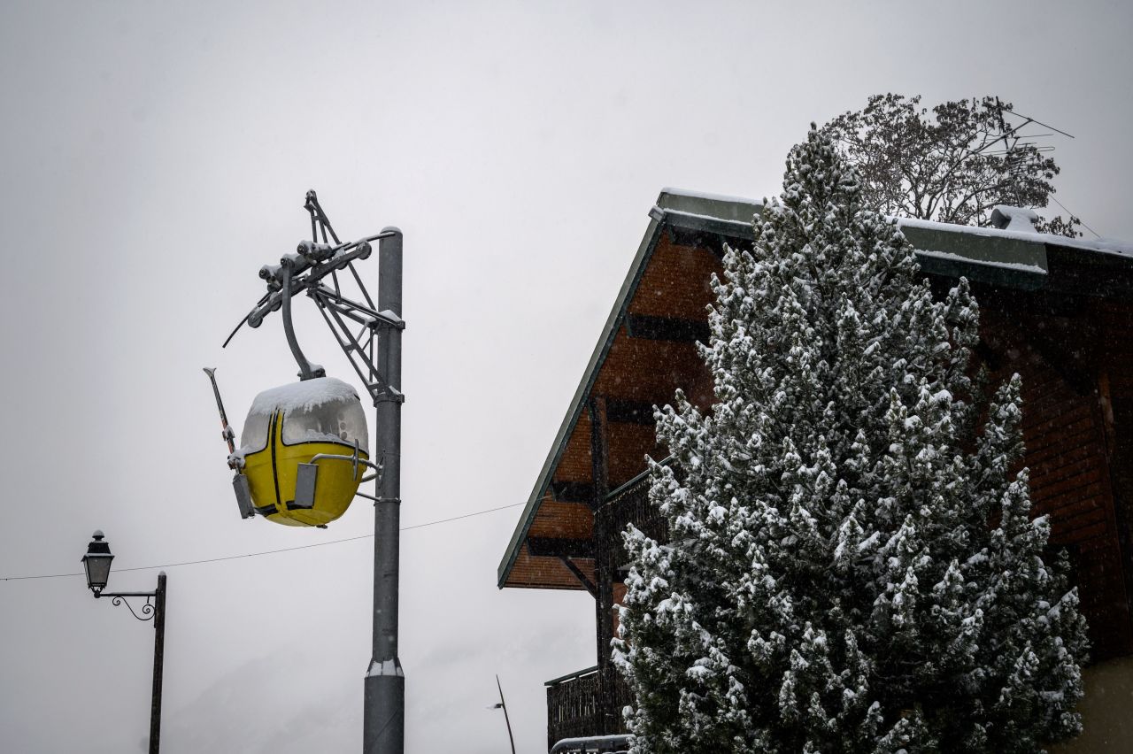 A snow covered gondola is seen hanging from a pole on December 1, in La Chapelle-d'Abondance, eastern France, a few kilometers from neighbouring Switzerland and its ski resorts.