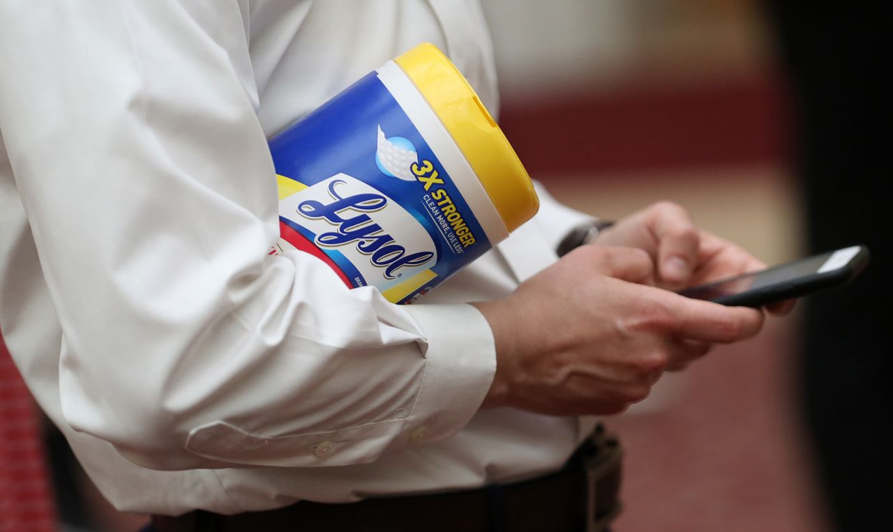 An attendee holds a container of Lysol disinfecting wipes as San Francisco Mayor London Breed speaks during a press conference on March 16 in San Francisco, California. 