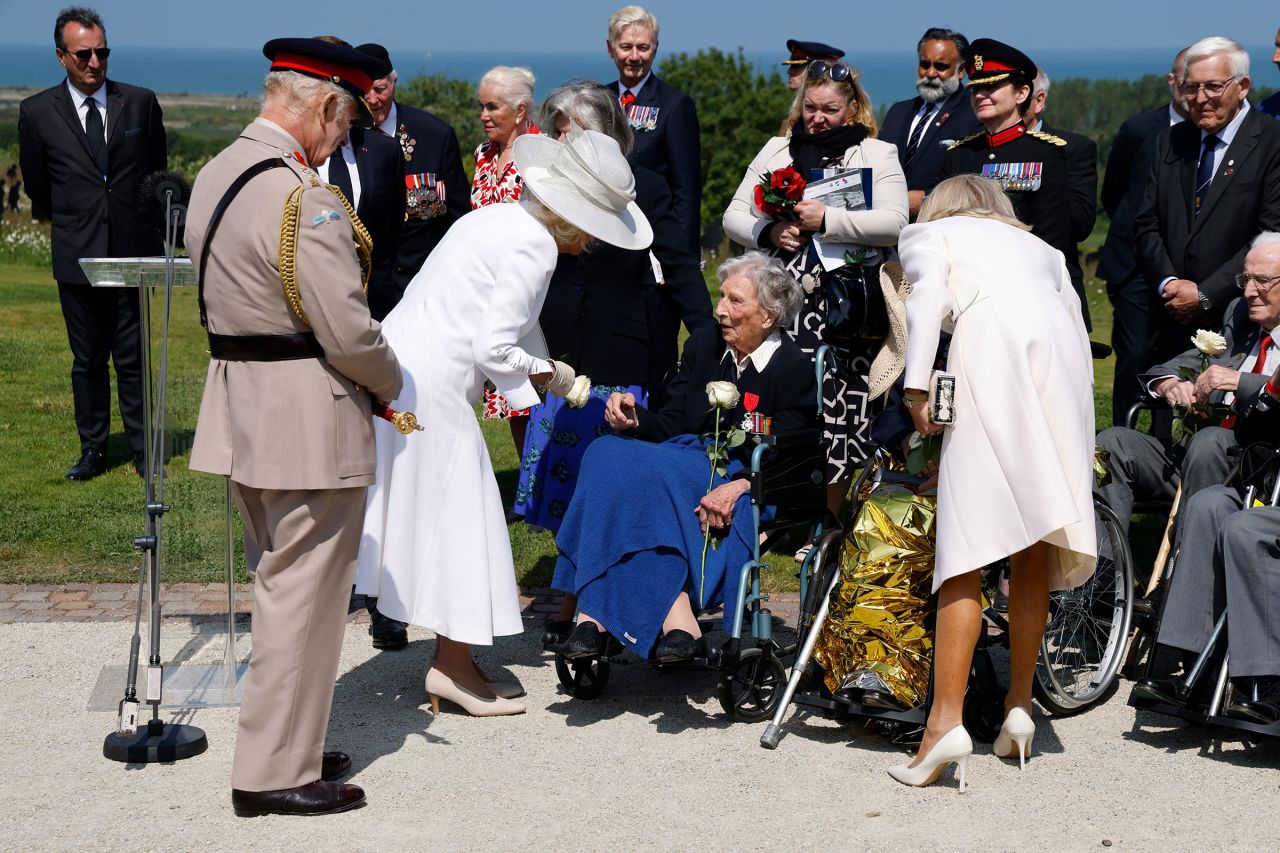 Britain's King Charles III, left, and Britain's Queen Camilla, second left, greet 104-years-old British World War II veteran Christian Lamb, center, who helped plan the D-Day landings in Normandy, on June 6.