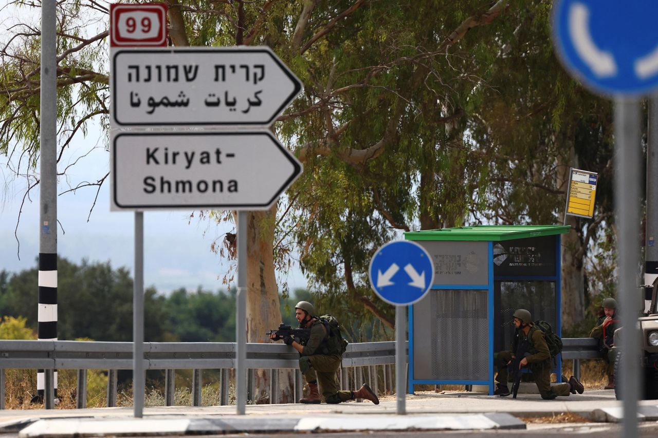 Israeli soldiers kneel in position on patrol in northern?Israel on October 10.