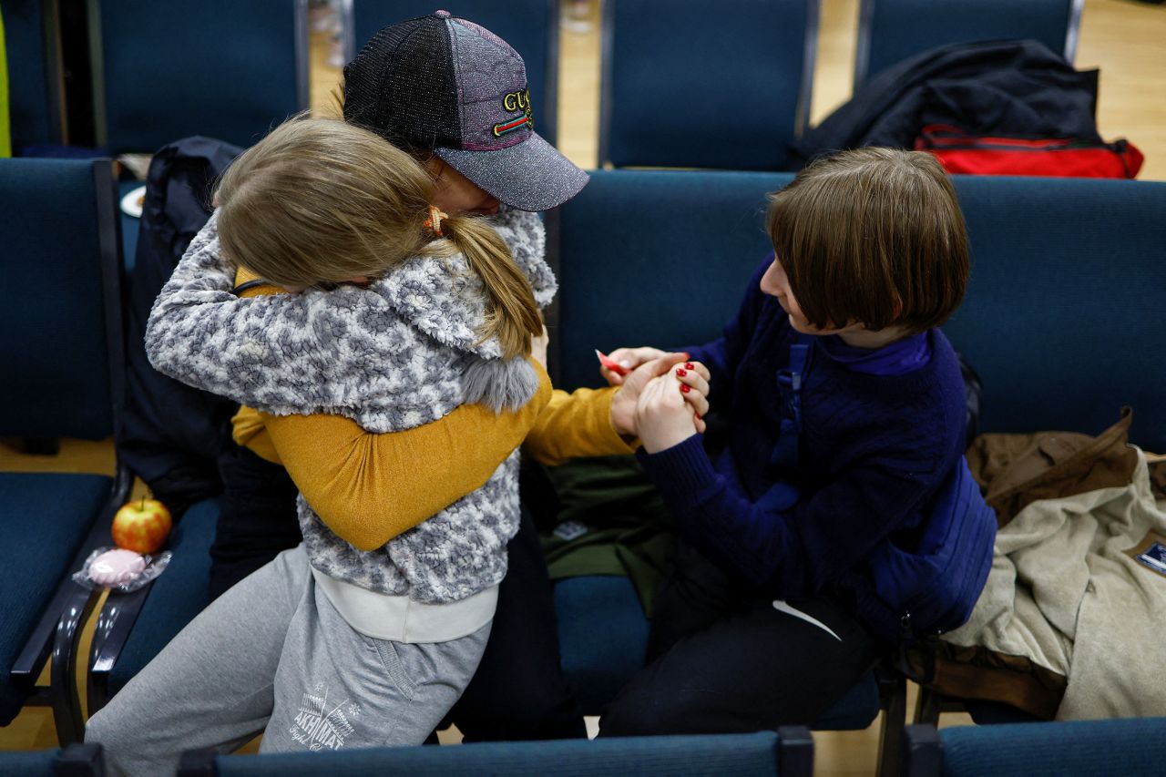Anastasiia holds her daughter Valeriia and son Maksym after being reunited in Kyiv on April 8. 