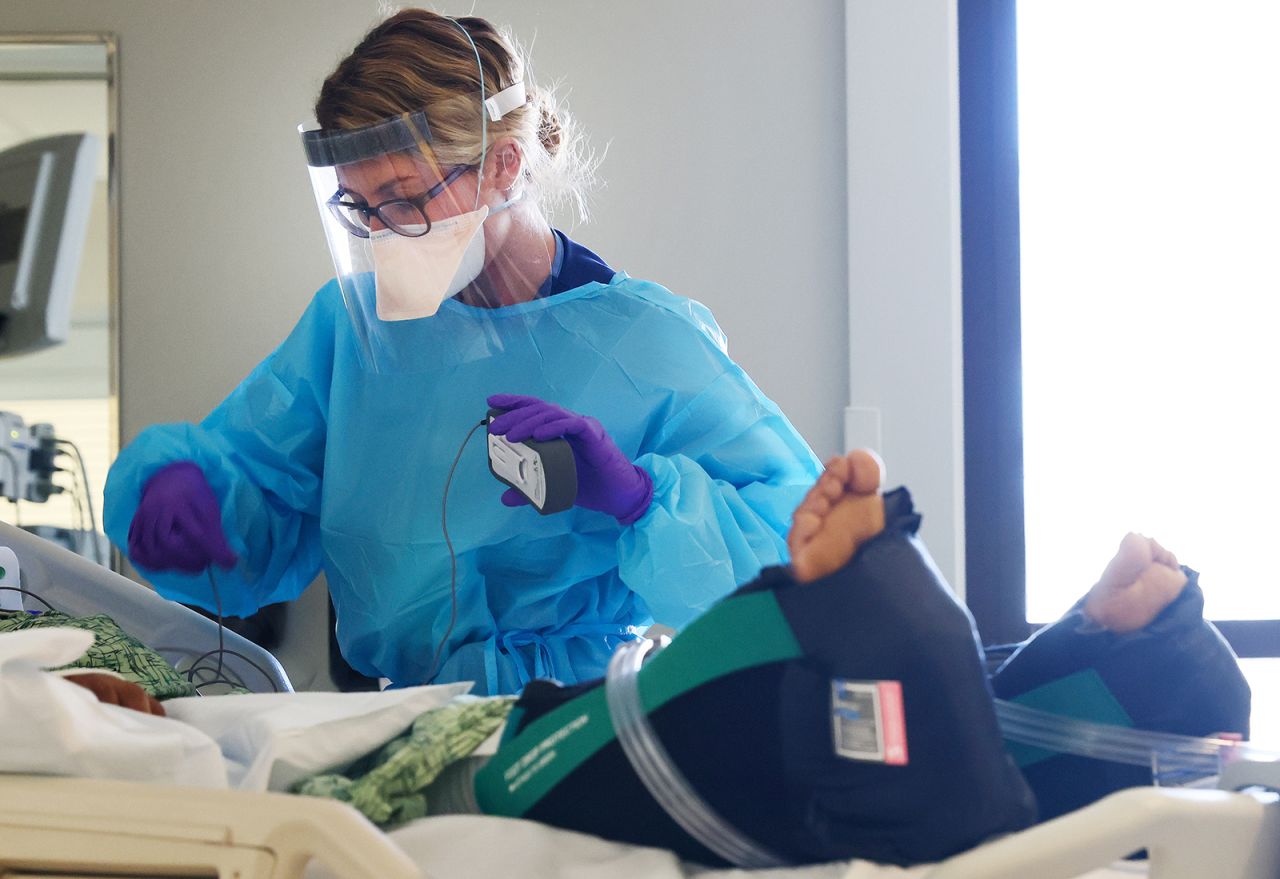  Registered nurse Ali Calhoun cares for a Covid-19 patient in the Intensive Care Unit at Sharp Memorial Hospital on December 15, in San Diego, California. 