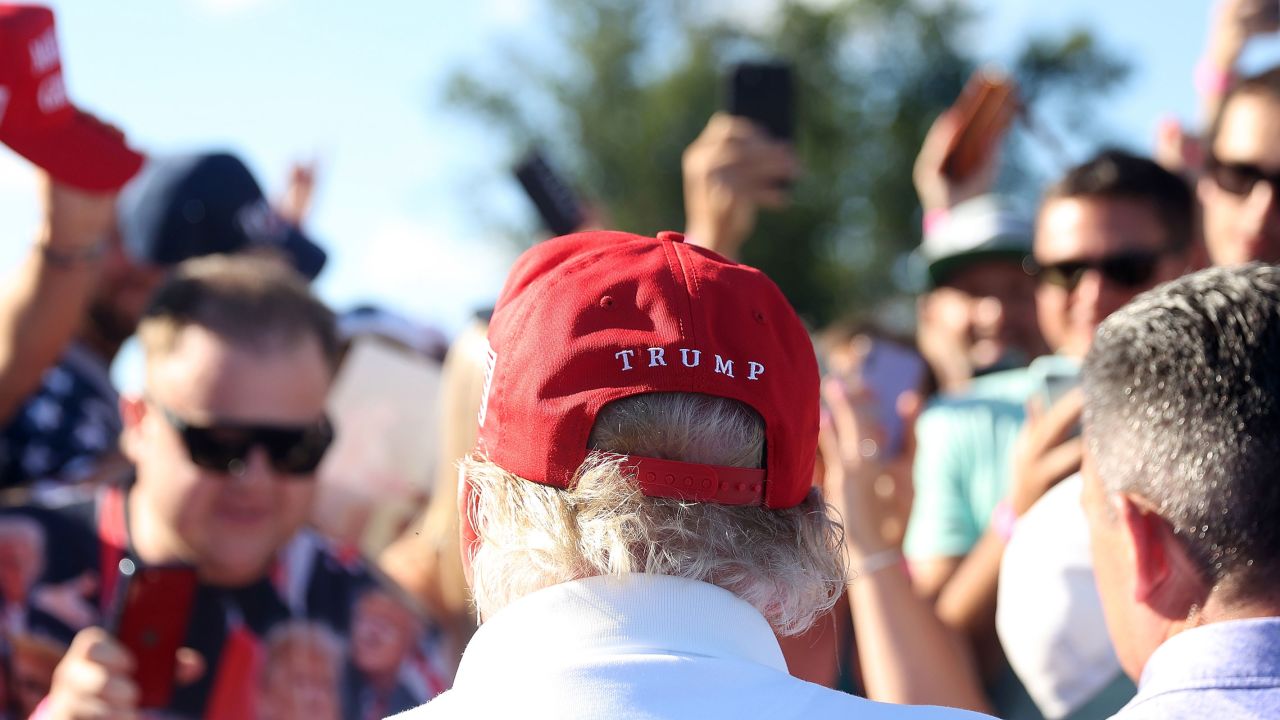 Former President Donald Trump signs autographs hits his shot from the 16th tee during day three of the LIV Golf Invitational - Bedminster at Trump National Golf Club on August 13, 2023 in Bedminster, New Jersey.