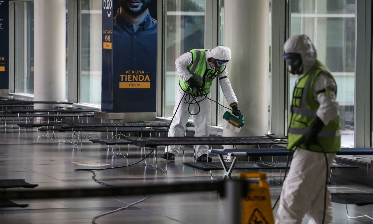 Airport employees disinfect the El Dorado International Airport, in Bogota, Colombia, on March 21.