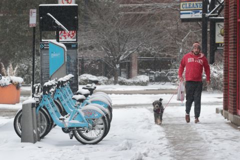Snow covers bicycles in the Bucktown neighborhood in Chicago Monday.