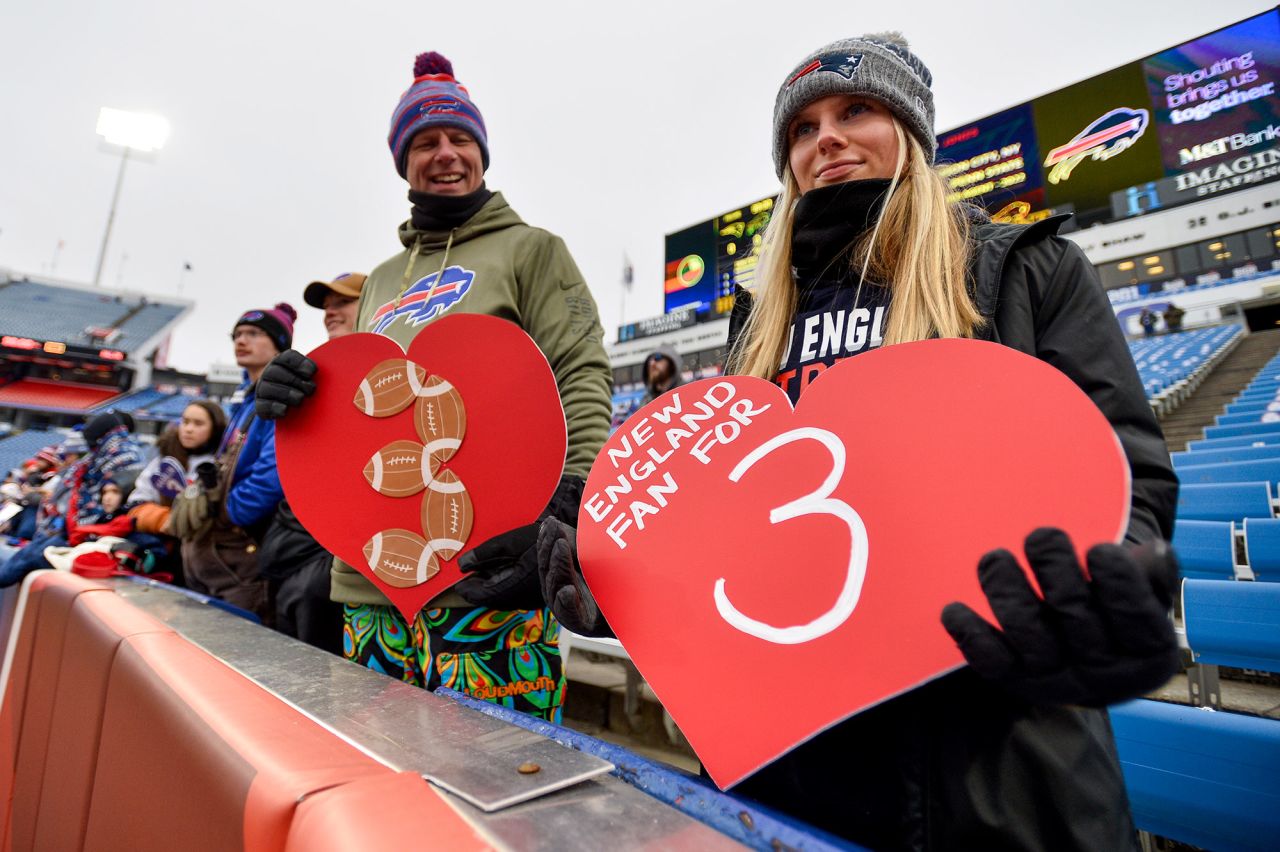 New England Patriots and Buffalo Bills fans hold signs in support of Damar Hamlin on Sunday, January 8.?