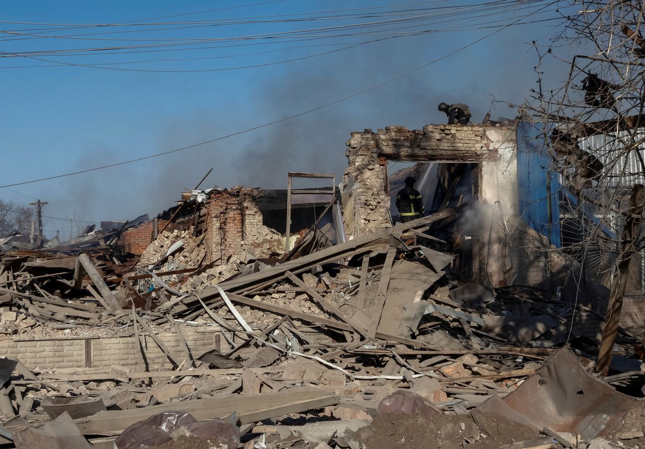 Rescuers work at the site of Russian air strikes in the village of Lyptsi, Ukraine, on April 10.