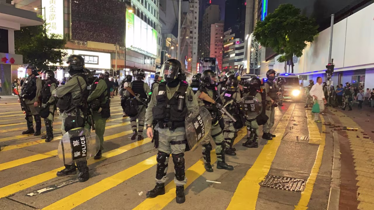 Riot police guard the street in Causeway Bay shopping district, Hong Kong. 