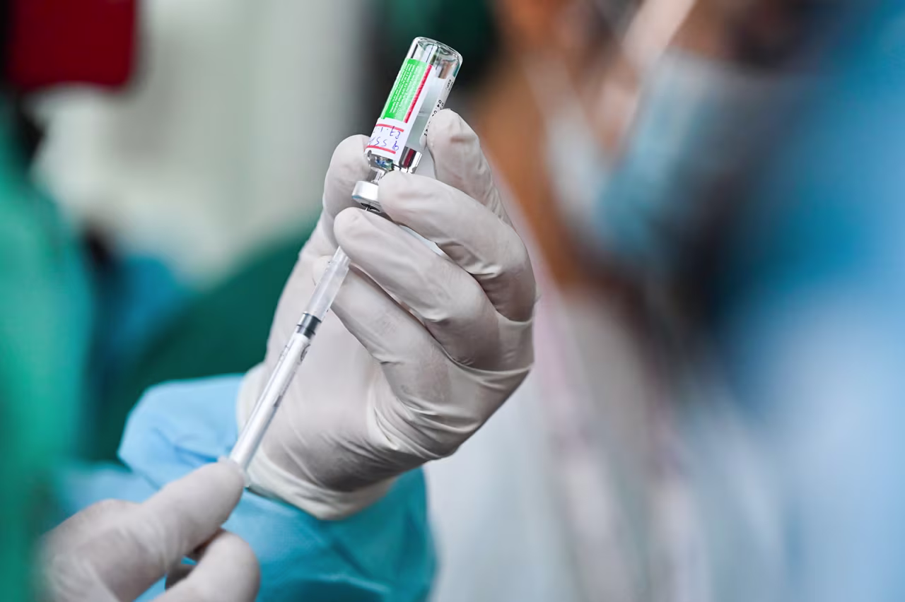 A health worker holds up a vial of AstraZeneca-Oxford's Covid-19 coronavirus vaccine on January 27.
