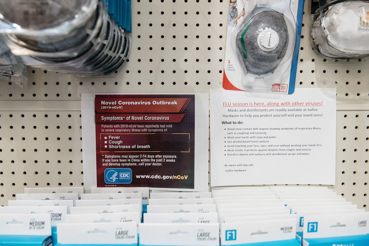 Signs detailing the Center for Disease Control's?advice for combatting Coronavirus are displayed above facemasks at a Manhattan hardware store in New York City on February 26.