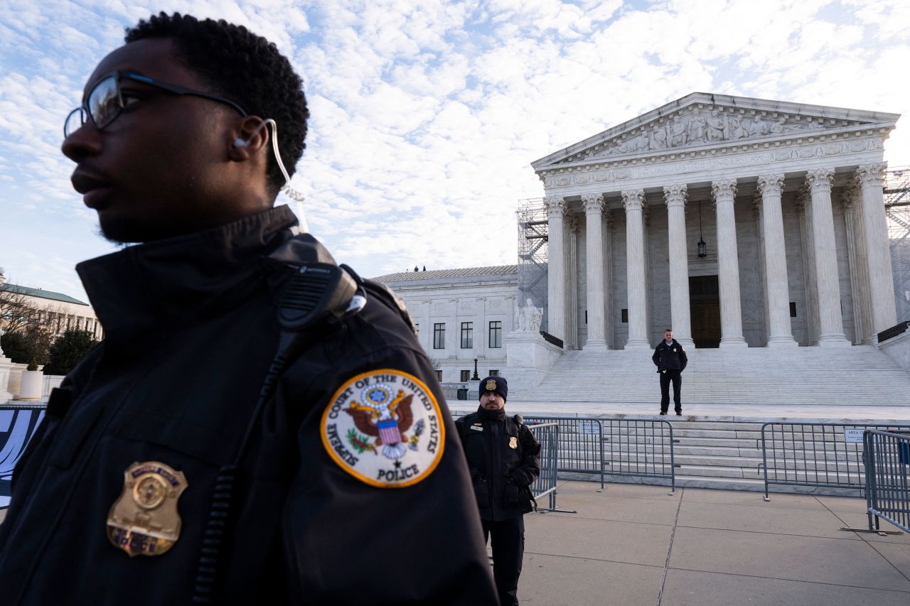 Police officers stand outside the Supreme Court in Washington, DC, on Thursday morning.