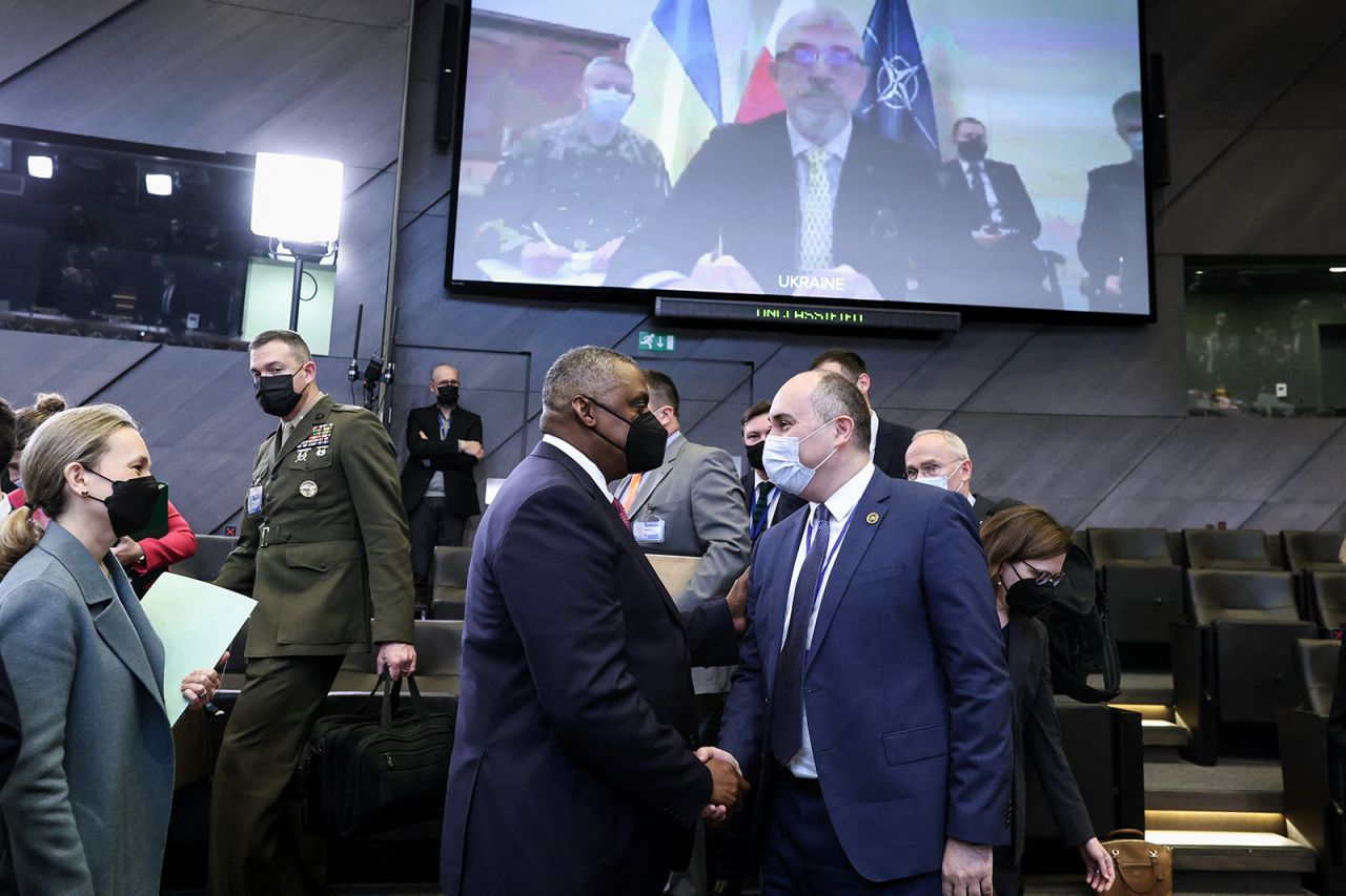 US Defense Secretary Lloyd Austin, center left, Georgian Defense Minister Juansher Burchuladze, center right, and Ukrainian Defense Minister Oleksiy Reznikov (on the screen) attend a NATO defense ministers meeting at NATO headquarters in Brussels, on February 17. 