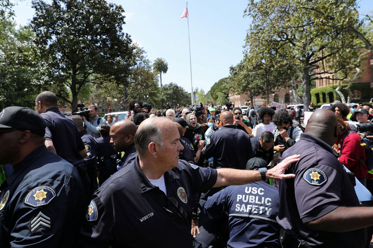 USC Safety officers try to disperse protestors at the University of Southern California's Alumni Park in Los Angeles on Wednesday, April 24.