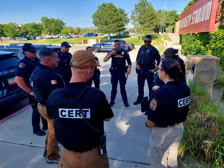 Brig. Gen. Romero, right and Command Sgt. Maj. Poccia, left, talk with members of the Albuquerque Police Department and the National Guard.