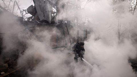 A firefighter works to extinguish a fire at a warehouse caused by recent Russian shelling in Kharkiv, Ukraine on April 14.