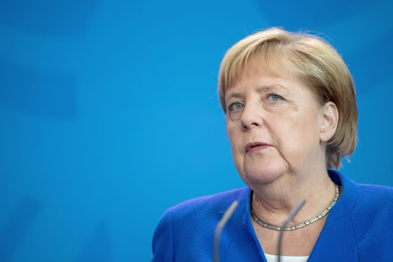 Angela Merkel talks to reporters on Wednesday.