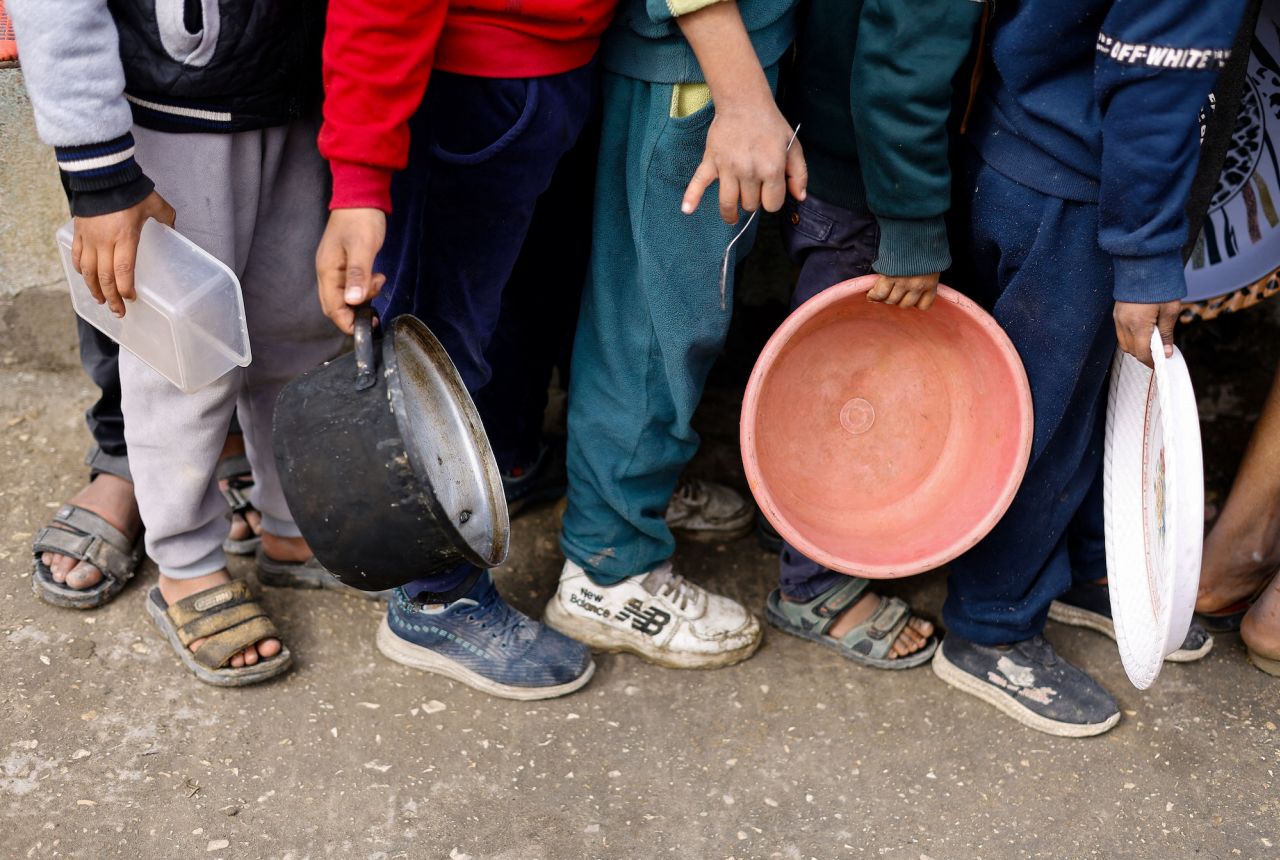 Palestinian children wait to receive food in Rafah, Gaza, on January 17.