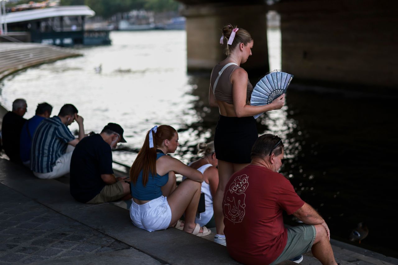 People cool down under the bridge at the Seine river during a heatwave in Paris, on July 30.