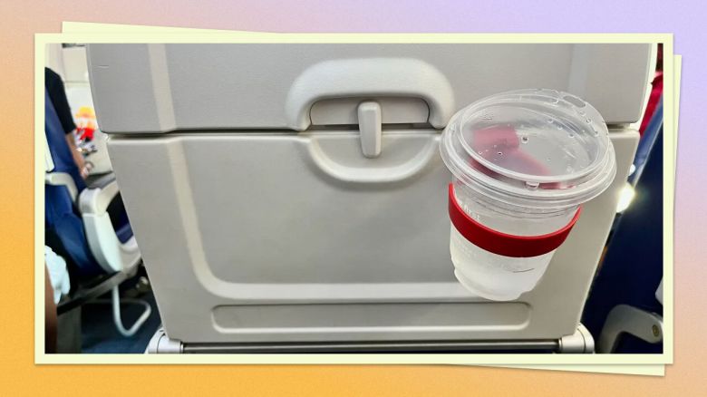 A photo of the FLYGA Airplane Drink or Phone Holder holding a cup of water