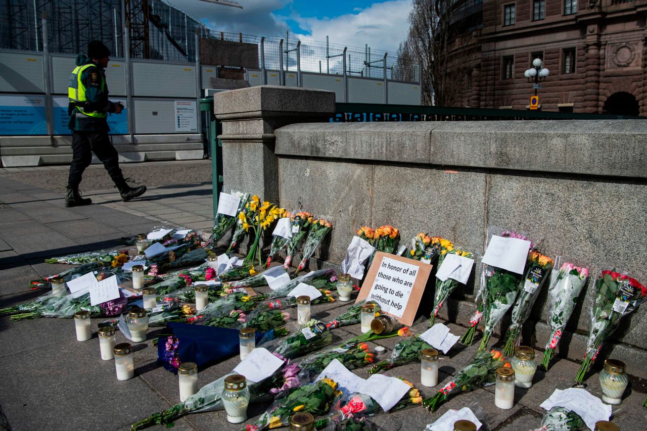 Picture taken on April 29, 2020 shows A memorial in Stockholm's Mynttorget square in memory of loved ones lost to the new coronavirus featuring candles, flowers and handwritten notes, some of which express frustration over Sweden's softer approach to curbing the illness. Flowers, candles and handwritten notes are