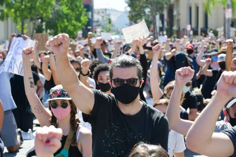 Protesters raise fists in solidarity at the Glendale Community March and Vigil for Black Lives Matter on June 7, in Glendale, California.