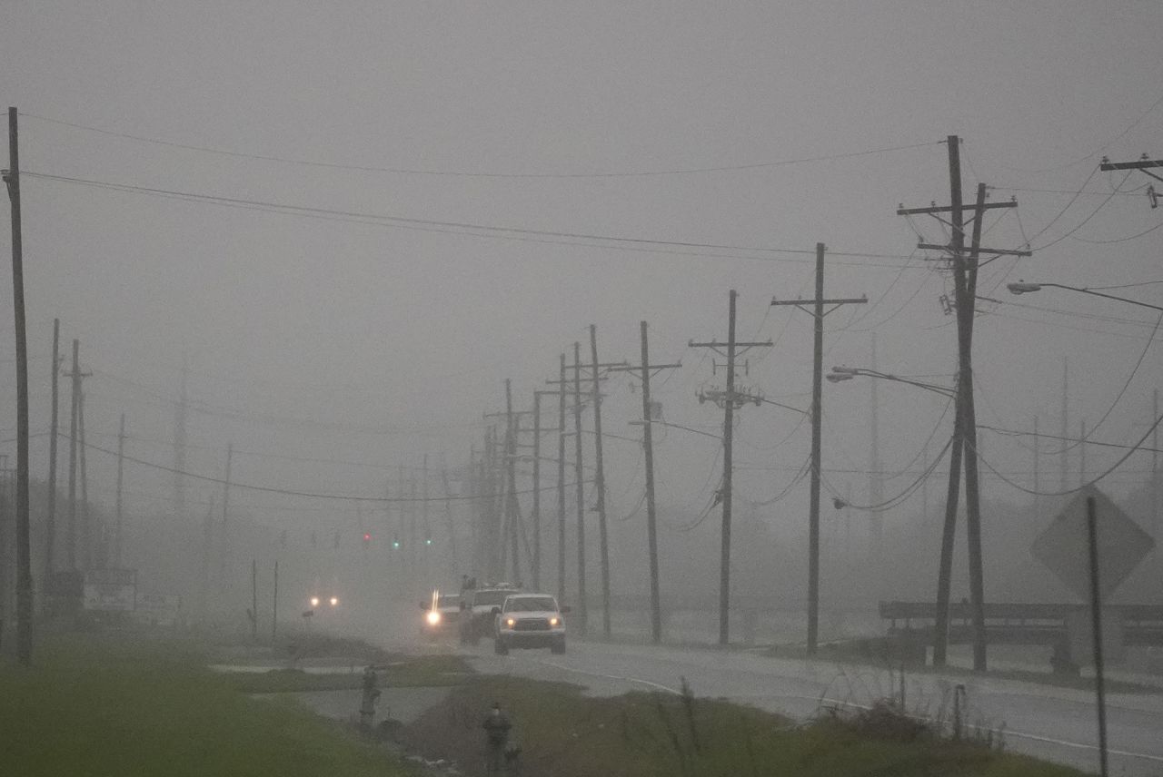 Cars drive through rain bands along Peter Rd., just outside New Orleans, ahead of Tropical Storm Francine, in Harvey, La., on Tuesday, September 10.