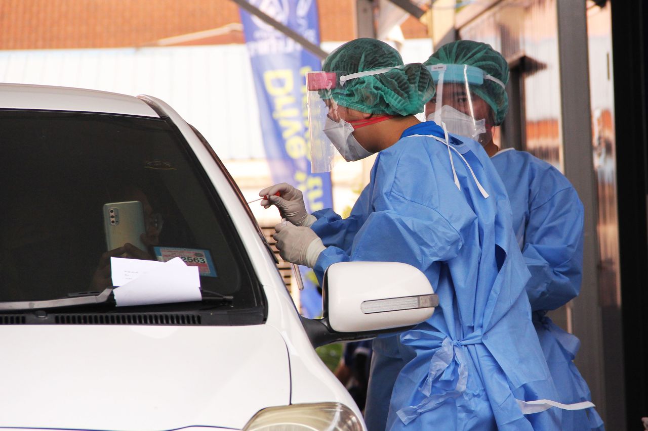 Nurses administer coronavirus tests at a drive-through testing center at Ramkhamhaeng Hospital on March 19 in Bangkok, Thailand.